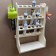 caulk tube storage organizer that holds 18 tubes of caulk and 2 caulking guns with a large shelf made of plywood on a cnc router project machine